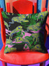 Square pillow cover featuring neon chartreuse tigers with cobalt blue stripes lounging among emerald green palm fronds on a black background with pink geometric accents.
