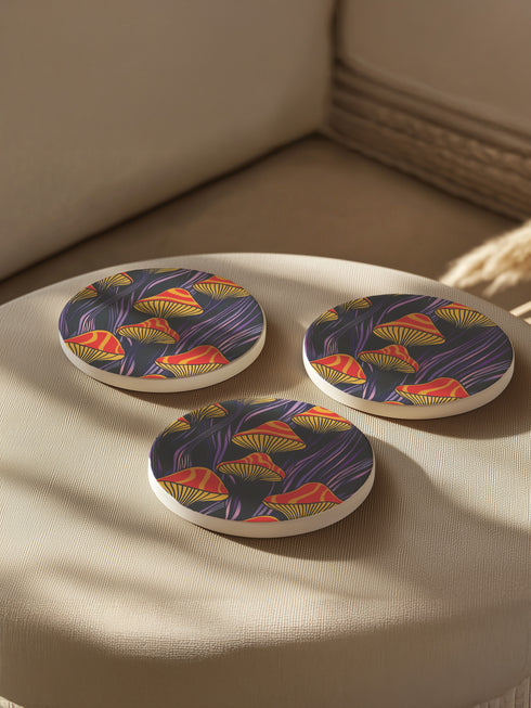 Round ceramic coaster featuring orange and yellow mushrooms with striped caps against a dark background with flowing purple lines in a psychedelic 70s style