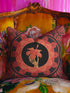 Square pillow cover featuring a golden skeleton hand holding a coral hibiscus flower, surrounded by fan-shaped coral motifs on a black background in an Art Nouveau style.