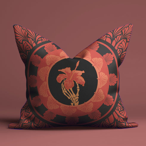 Square pillow cover featuring a golden skeleton hand holding a coral hibiscus flower, surrounded by fan-shaped coral motifs on a black background in an Art Nouveau style.