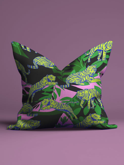 Square pillow cover featuring neon chartreuse tigers with cobalt blue stripes lounging among emerald green palm fronds on a black background with pink geometric accents.