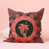 Square pillow cover featuring a golden skeleton hand holding a coral hibiscus flower, surrounded by fan-shaped coral motifs on a black background in an Art Nouveau style.