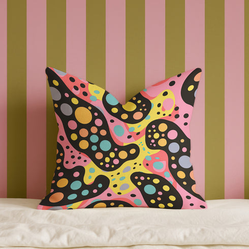 Psychedelic polka dot pillow cover with abstract swirls and colorful circles in pastel pink, yellow, aqua, and black. The pattern features bubbly, wavy shapes resembling pop art and retro lava lamp vibes. Made of durable polyester with a soft linen texture, shown on a pink background. Double-sided full-color design with hidden zipper. Available in 18x18 and 22x22 sizes. Bold dopamine decor for maximalist spaces.