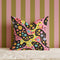 Psychedelic polka dot pillow cover with abstract swirls and colorful circles in pastel pink, yellow, aqua, and black. The pattern features bubbly, wavy shapes resembling pop art and retro lava lamp vibes. Made of durable polyester with a soft linen texture, shown on a pink background. Double-sided full-color design with hidden zipper. Available in 18x18 and 22x22 sizes. Bold dopamine decor for maximalist spaces.