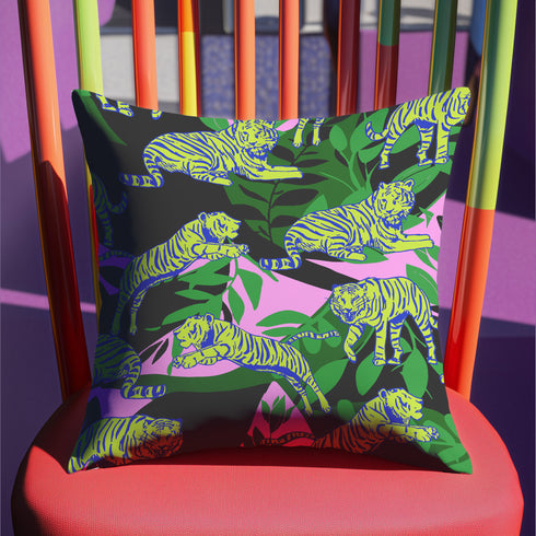 Square pillow cover featuring neon chartreuse tigers with cobalt blue stripes lounging among emerald green palm fronds on a black background with pink geometric accents.