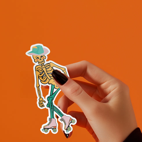 A sticker featuring a whimsical skeleton dressed in a green cowboy hat, casually posed with one leg propped up. The skeleton sports a full grin and is adorned with vibrant teal and orange roller skates, adding a playful and surreal touch to the design.