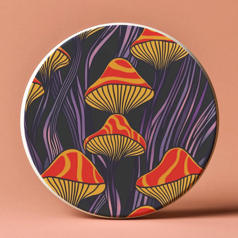 Round ceramic coaster featuring orange and yellow mushrooms with striped caps against a dark background with flowing purple lines in a psychedelic 70s style