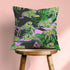 Square pillow cover featuring neon chartreuse tigers with cobalt blue stripes lounging among emerald green palm fronds on a black background with pink geometric accents.