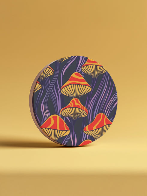Round ceramic coaster featuring orange and yellow mushrooms with striped caps against a dark background with flowing purple lines in a psychedelic 70s style