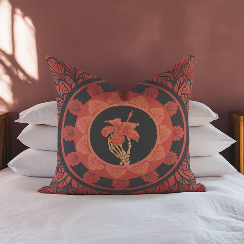 Square pillow cover featuring a golden skeleton hand holding a coral hibiscus flower, surrounded by fan-shaped coral motifs on a black background in an Art Nouveau style.