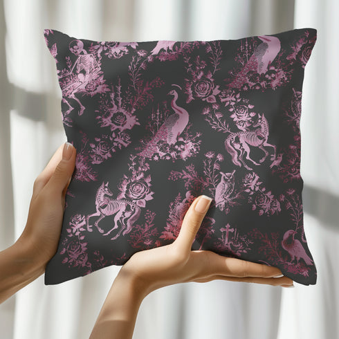 Luxury throw pillow cover featuring a gothic toile pattern in lavender on a black background, with skeletal figures, peacocks, and floral motifs.
