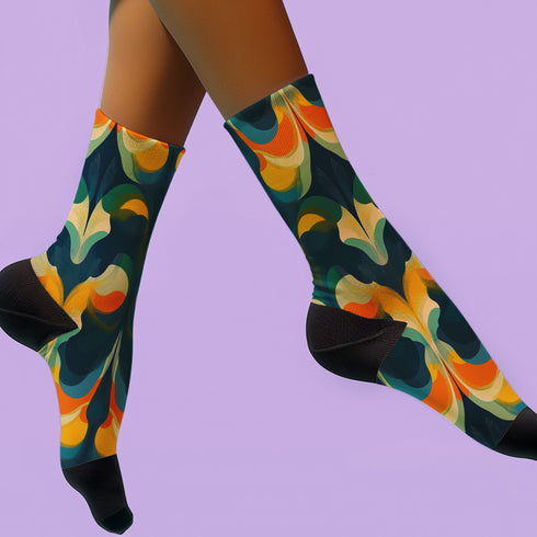 Crew socks featuring a bold ‘70s-style abstract swirl pattern in deep green, orange, yellow, and navy blue.