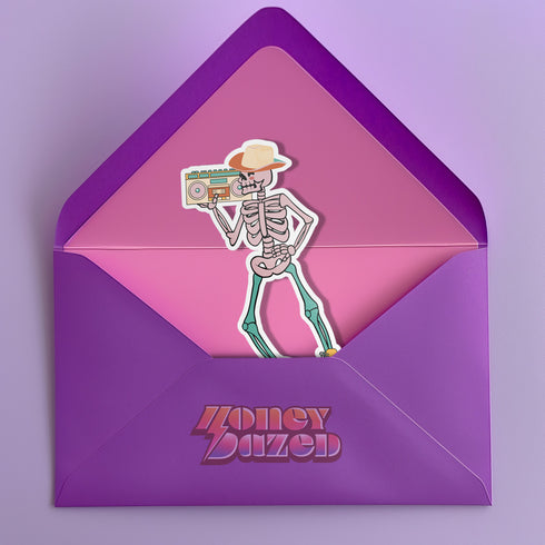Sticker featuring a skeleton wearing a cowboy hat and holding a boombox on its shoulder, clad in roller skates. Perfect for adding a playful touch to any surface.