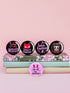 A set of five glossy round pinback buttons with pastel goth and kawaii punk designs, featuring slogans like "Eat The Rich" and "Smash Fascism" in bold pink and black. Each pin has a cute character delivering a powerful message.