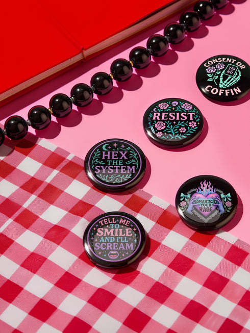 Set of five 2.25-inch round button pins featuring feminist and witchy designs with pastel artwork on a black background. Includes slogans like “Hex the System,” “Tell Me to Smile and I’ll Scream,” “Romanticize Your Rage,” “Consent or Coffin,” and “Resist.” Each button has a safety pin backing, a durable tinplate body, and a glossy, scratch and UV-resistant finish with purple, pink, teal, and mint accents.
