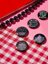 Set of five 2.25-inch round button pins featuring feminist and witchy designs with pastel artwork on a black background. Includes slogans like “Hex the System,” “Tell Me to Smile and I’ll Scream,” “Romanticize Your Rage,” “Consent or Coffin,” and “Resist.” Each button has a safety pin backing, a durable tinplate body, and a glossy, scratch and UV-resistant finish with purple, pink, teal, and mint accents.