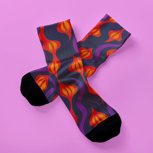 Black crew socks featuring a fiery red, orange, and purple lava-lamp-inspired wave pattern.