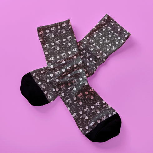 Black crew socks featuring a white skull and cherry pattern.