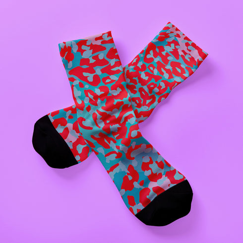 Dive into bold fashion with these vibrant socks featuring an eye-catching red, blue, and pink cheetah print pattern. Perfect for those who love to make a statement, these socks are ideal for brightening up any outfit and showcasing your unique style. Comfortable and stylish with black heels and toes, they are a must-have accessory for the fashion-forward.
