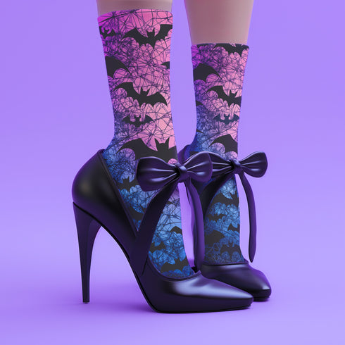 Black crew socks featuring an ombre pink-to-blue gradient with silhouetted bats and spiderweb details.