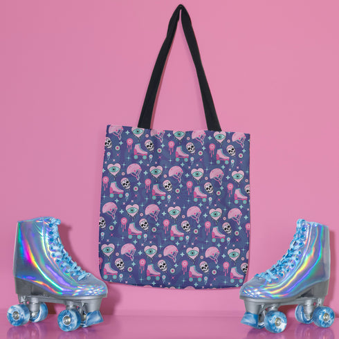 Tote bag with black handles and a purple background featuring a repeating pattern of pink roller skates, white skulls, pink helmets, teal eyeballs, and pink jellyfish-like shapes. The design has a spooky yet playful vibe, combining roller derby elements with supernatural motifs. The overall aesthetic is quirky, retro-inspired, and perfect for skate enthusiasts with a taste for the unconventional.