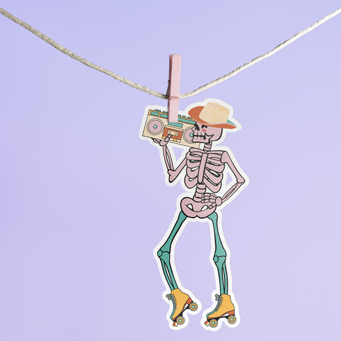 Sticker featuring a skeleton wearing a cowboy hat and holding a boombox on its shoulder, clad in roller skates. Perfect for adding a playful touch to any surface.