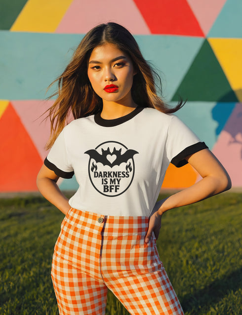 Unisex off-white and black ringer t-shirt with black bat and heart graphic and the phrase "Darkness Is My BFF" in bold gothic style, contrasting black ribbed collar and cuffs, vintage-inspired, available in sizes S-3XL, soft 100% cotton, alternative fashion, perfect goth gift.