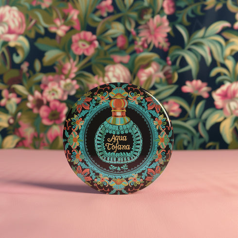 Circular pinback button featuring an ornate teal poison bottle labeled "Aqua Tofana" on black background, framed by decorative coral and turquoise flowers. Gothic feminist history pin with glossy finish and safety pin backing, available in 2" and 3" sizes for witch aesthetic fashion.