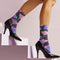 Black crew socks with an allover design of iridescent neon mushrooms in shades of pink, blue, and purple.