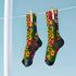 Colorful dopamine-infused crew socks with an all-over print featuring abstract flowers and leopard spots in bold hues of pink, purple, yellow, green, and black. Made of plush polyester-spandex blend, with black toe and heel accents. Designed to fit women’s US 5 to men’s US 12 shoe sizes.