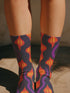 Black crew socks featuring a fiery red, orange, and purple lava-lamp-inspired wave pattern.