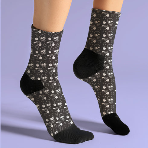 Black crew socks featuring a white skull and cherry pattern.