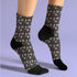 Black crew socks featuring a white skull and cherry pattern.