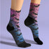 Black crew socks featuring an ombre pink-to-blue gradient with silhouetted bats and spiderweb details.