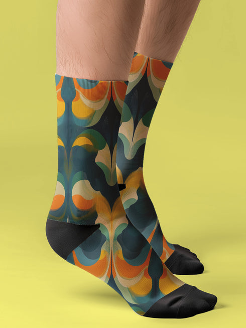 Crew socks featuring a bold ‘70s-style abstract swirl pattern in deep green, orange, yellow, and navy blue.