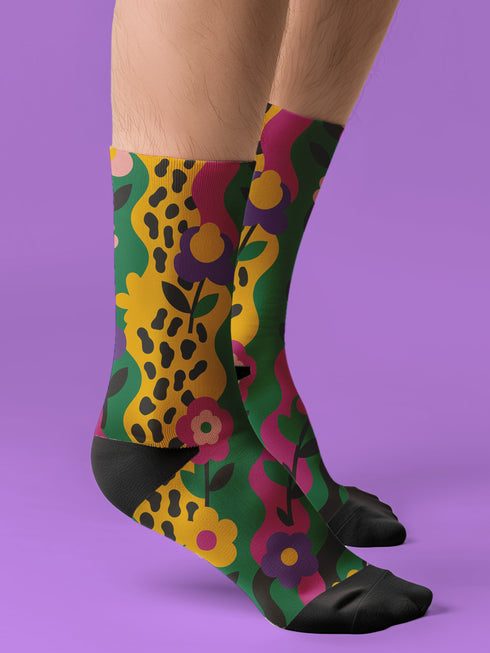 Colorful dopamine-infused crew socks with an all-over print featuring abstract flowers and leopard spots in bold hues of pink, purple, yellow, green, and black. Made of plush polyester-spandex blend, with black toe and heel accents. Designed to fit women’s US 5 to men’s US 12 shoe sizes.