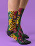 Colorful dopamine-infused crew socks with an all-over print featuring abstract flowers and leopard spots in bold hues of pink, purple, yellow, green, and black. Made of plush polyester-spandex blend, with black toe and heel accents. Designed to fit women’s US 5 to men’s US 12 shoe sizes.