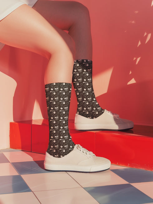 Black crew socks featuring a white skull and cherry pattern.