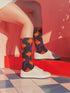 Black crew socks featuring a fiery red, orange, and purple lava-lamp-inspired wave pattern.