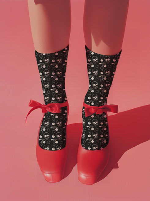 Black crew socks featuring a white skull and cherry pattern.
