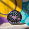 Glossy black pinback button featuring pastel gothic artwork with the phrase "Romanticize Your Rage" in bold white and lavender lettering. The design includes a pink glitter heart, a silver dagger, mint green bow, roses, stars, and delicate vines. Styled against a pink and purple gradient background, this round button blends soft romantic visuals with fierce messaging, perfect for pastel goth, feminist, or alternative fashion aesthetics.