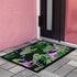 Vibrant doormat featuring stylized yellow tigers with blue stripes amidst green foliage and pink accents on a black background. Bold, maximalist design for indoor/outdoor use.