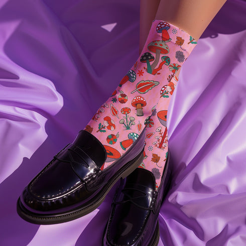 Cute mushroom-themed pink socks with various fungi and nature illustrations, black heels and toes, ideal for casual wear or gifting