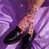 Cute mushroom-themed pink socks with various fungi and nature illustrations, black heels and toes, ideal for casual wear or gifting