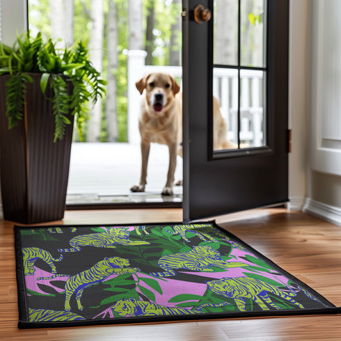 Vibrant doormat featuring stylized yellow tigers with blue stripes amidst green foliage and pink accents on a black background. Bold, maximalist design for indoor/outdoor use.