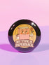 A glossy black round pin-back button with a retro 1970s-style design. The center shows a smiling cartoon paperback book holding a red rose, colored light brown with white gloves and feet. Below, “MY TYPE IS PAPERBACK” appears in chunky brown-and-tan 70s lettering. This bookish flair piece has a high-gloss, scratch-resistant mylar finish, secure safety pin backing, and comes in two- or three-inch sizes.