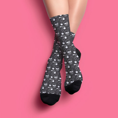 Black crew socks featuring a white skull and cherry pattern.