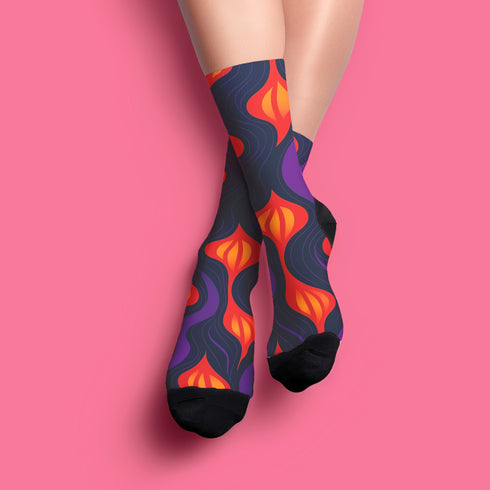 Black crew socks featuring a fiery red, orange, and purple lava-lamp-inspired wave pattern.