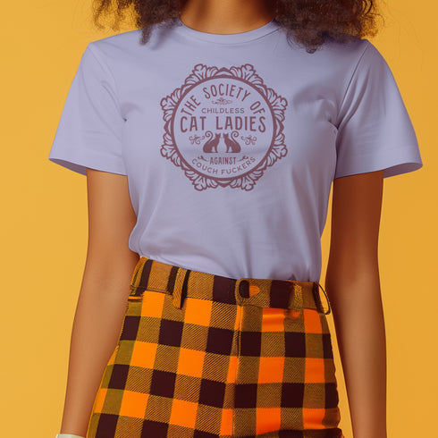 The Society of Childless Cat Ladies Against Couch Fuckers" 2024 election T Shrort design featuring two cats in an ornate circular frame, available in white and purple.
