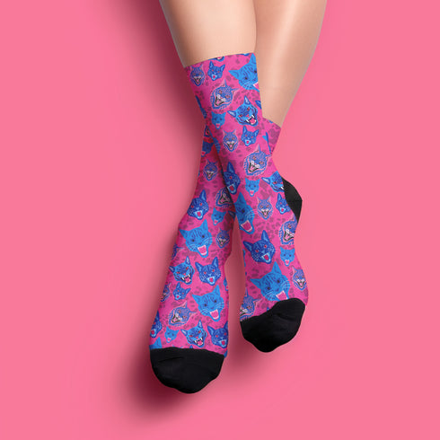 Fun and playful socks adorned with vibrant tiger head motifs on a pink background, with black heels and toes, ideal for animal lovers and those who enjoy unique designs